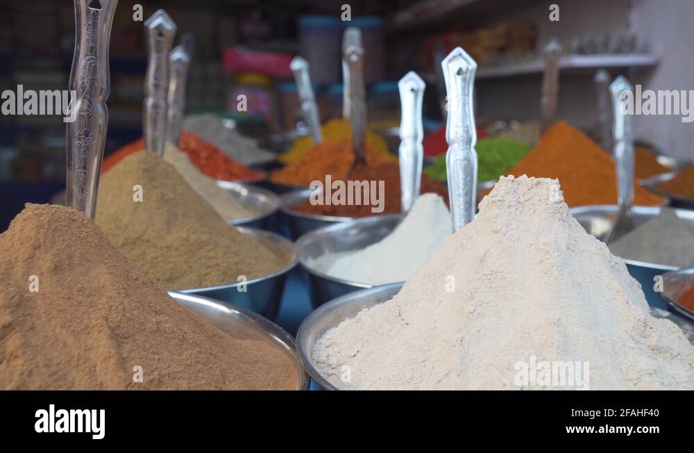 Pan from left to right close up through colourful piles of mixed herbs