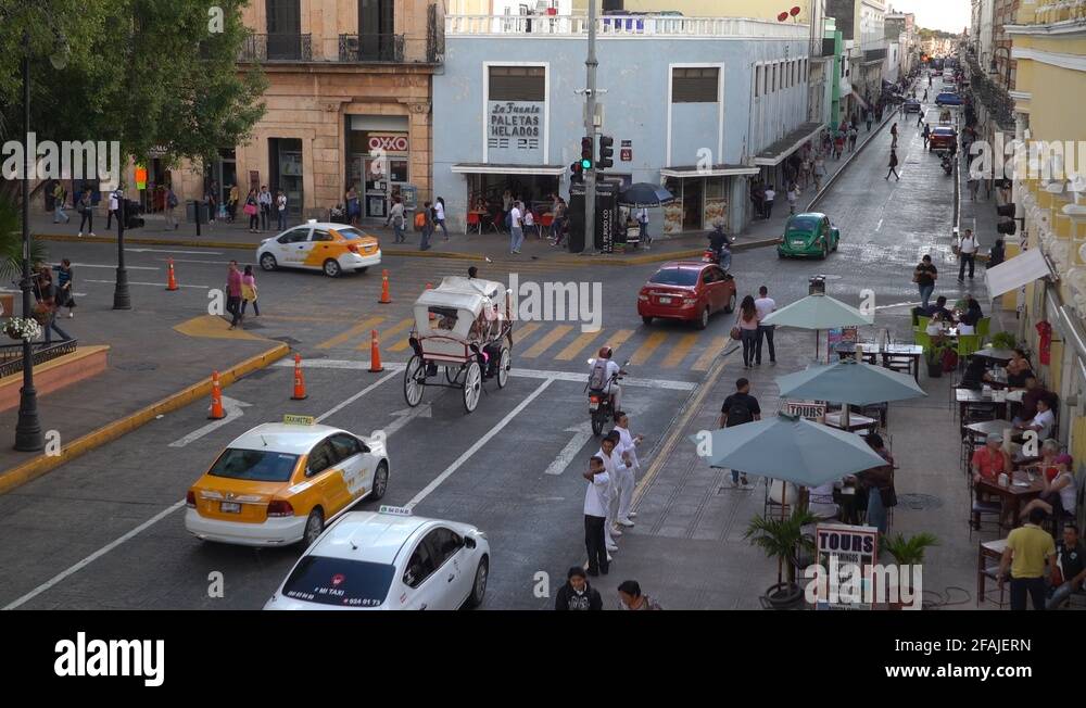 Overhead shot of horse drawn carriage turning a corner on the street in