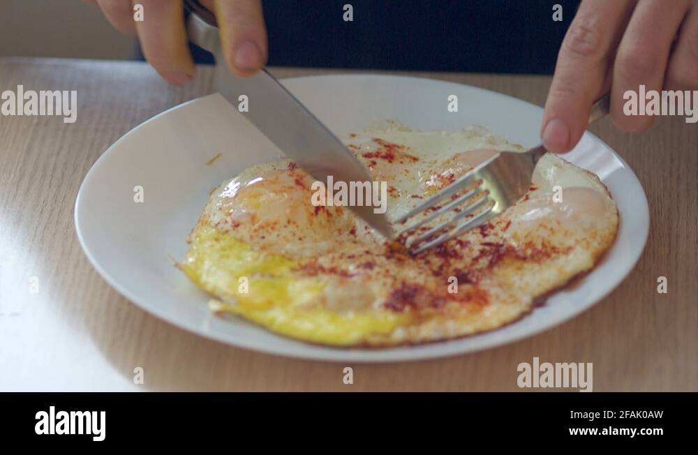 man eating scrambled eggs for Breakfast, closeup Stock Video Footage Alamy