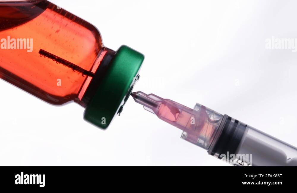 Syringe Drawing Liquid Medicine from a Glass Medical Vial Stock Video