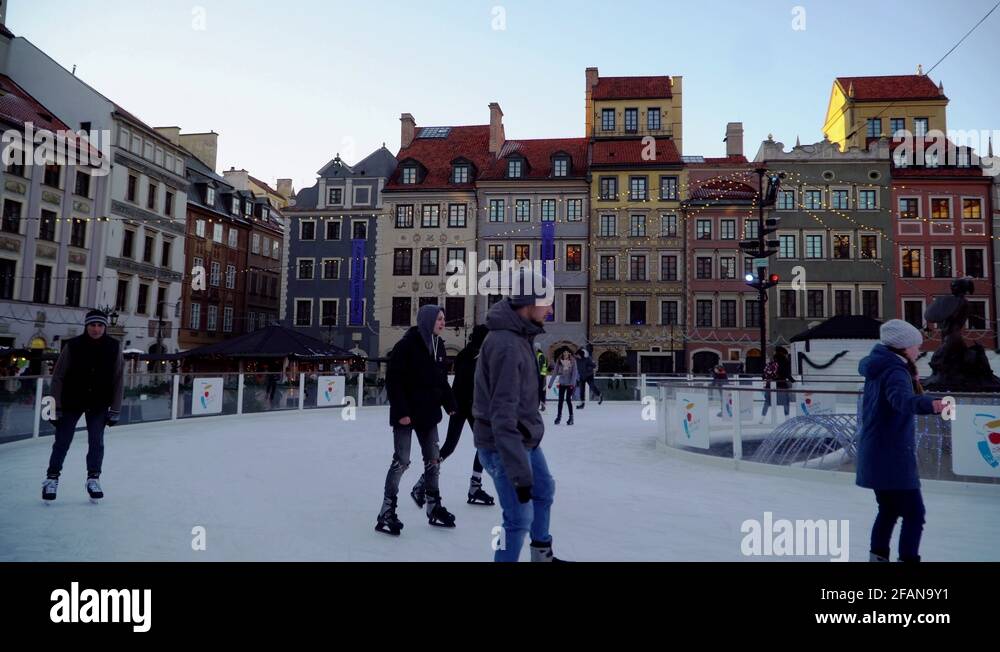 People ice skating curve in Old Town ice rink amidst residential texture Stock Video Footage Alamy