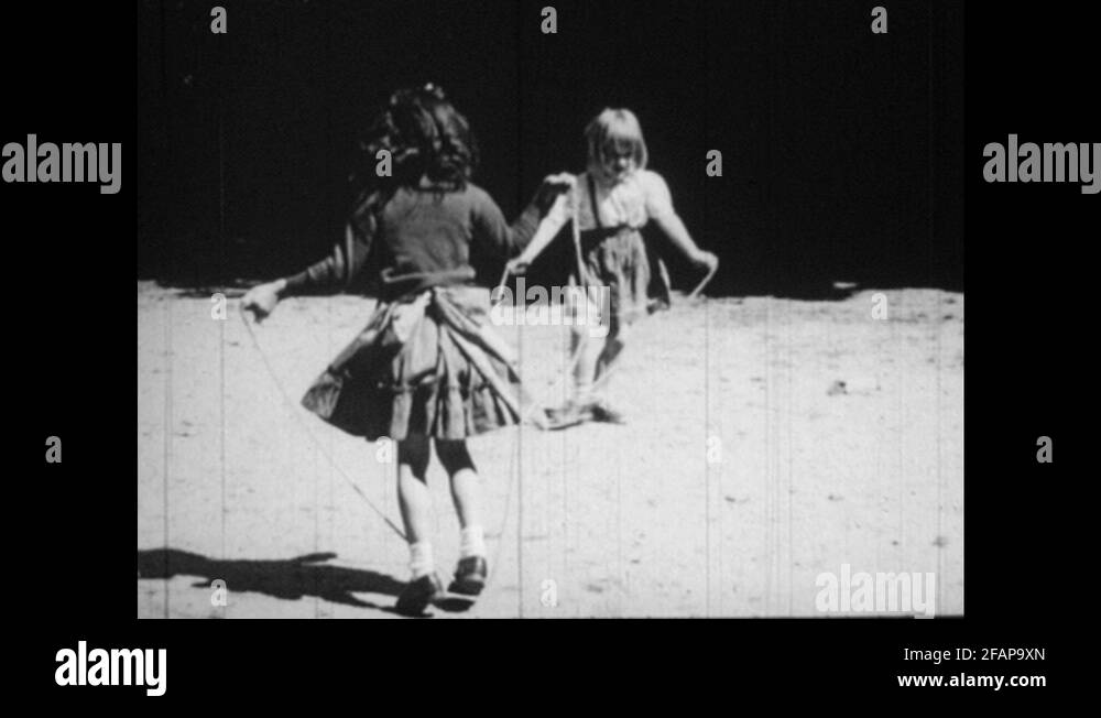 1950s Girls jumping rope, title superimposed over image. Girl bouncing ball Stock Video Footage
