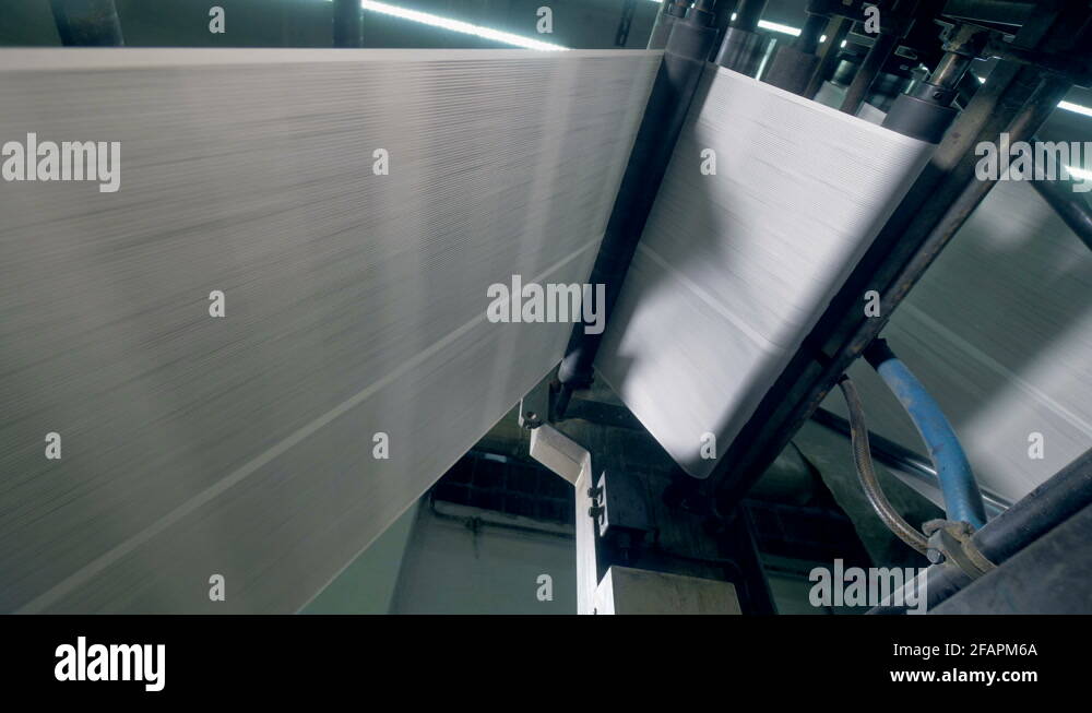 Printed newspaper moving on a rolling conveyor, bottom view Stock Video