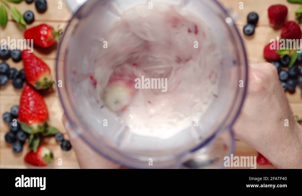 Fruit and milk mixing into blender. Top view. Blending Ingredients