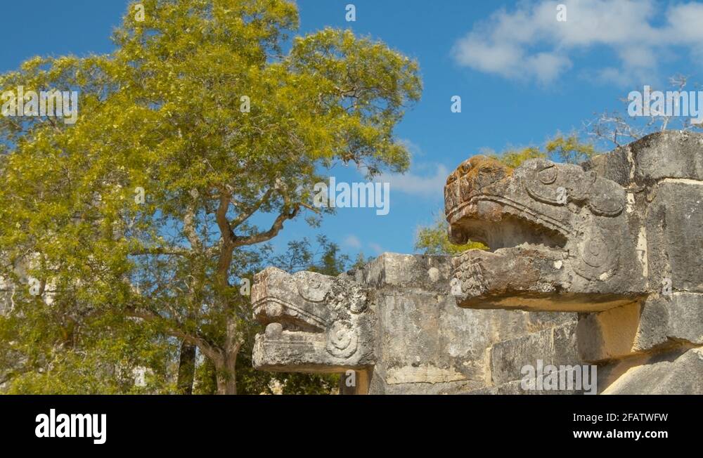 Two Mayan Jaguar Sculpture ruins in Chichen Itza with background of