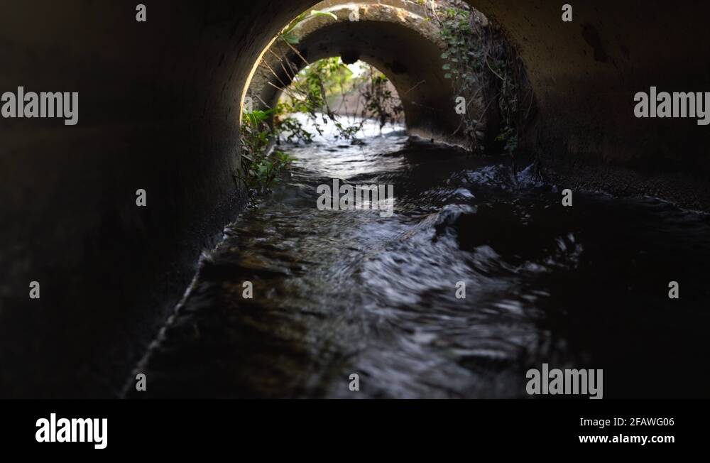 Water flowing in water tunnel used in irrigation for farmland Stock