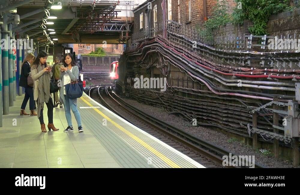 London Underground District Line Train arriving at Whitechapel Station ...
