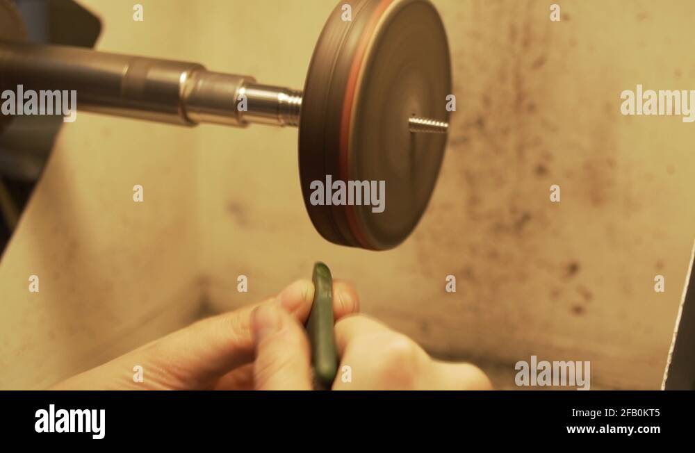 Polishing green stone from New Zealand with disc polisher in slow motion Stock Video Footage Alamy