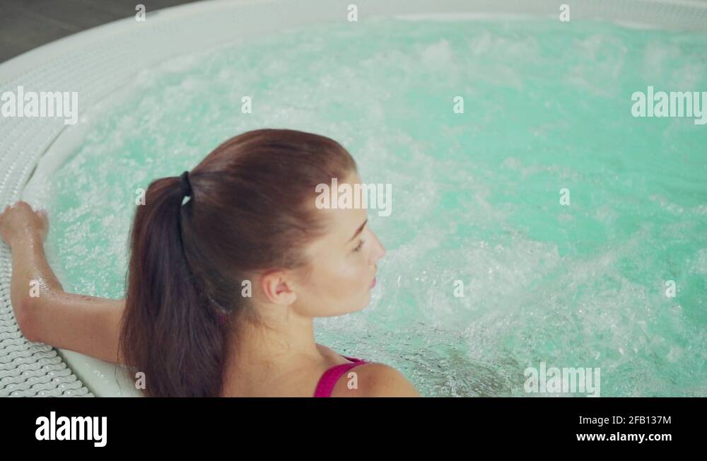 Relaxed woman sitting in hot jacuzzi hydromassage bathtub Stock Video