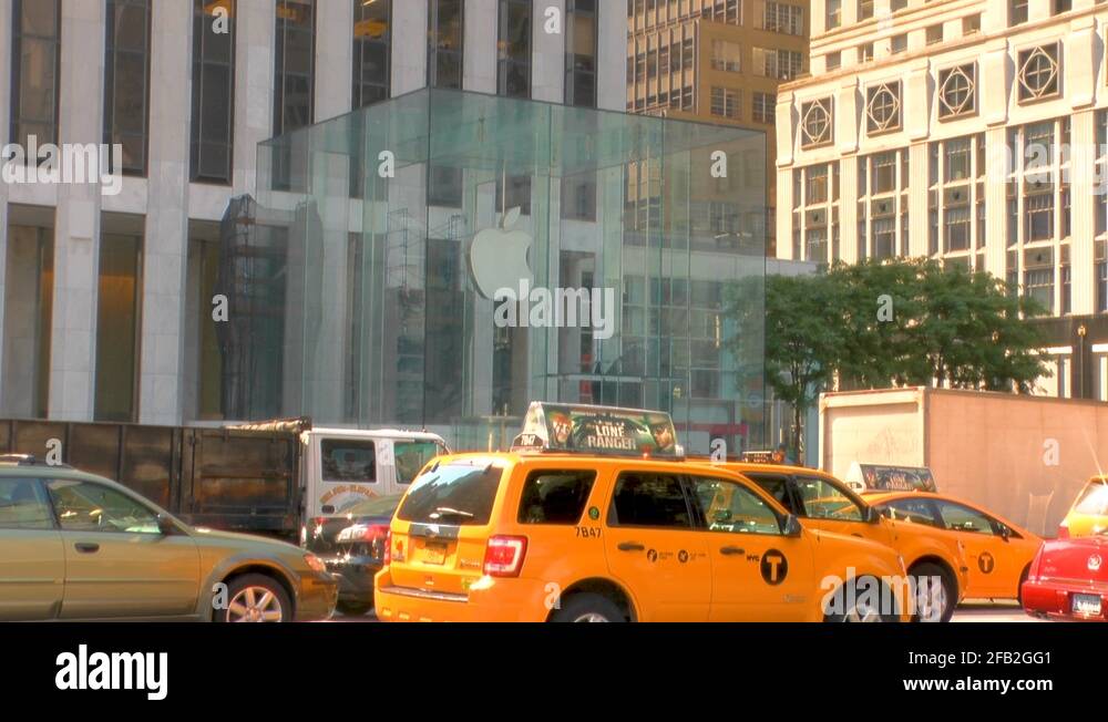 The view of the Apple Store and cars passing in New York City Stock