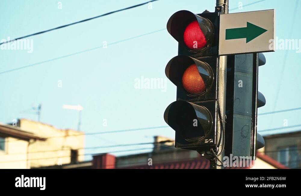 A red traffic light turns green. Close up urban city traffic light