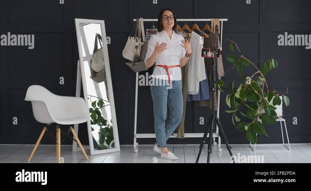 Female boutique owner vlogging about new dress and accessory Stock Video Footage Alamy