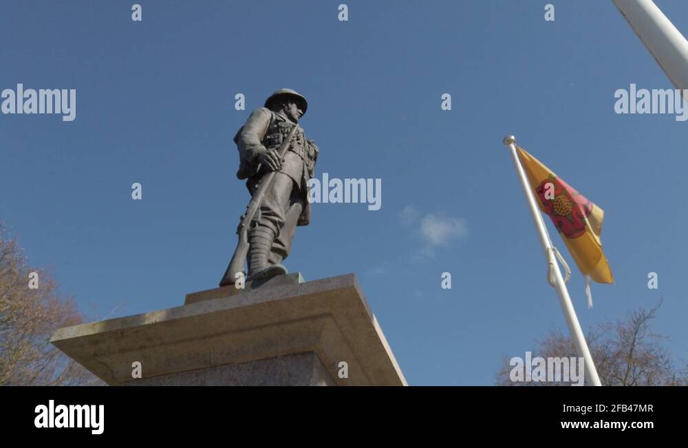 Low angle perspective rotation around Carnforth war memorial. Bronze