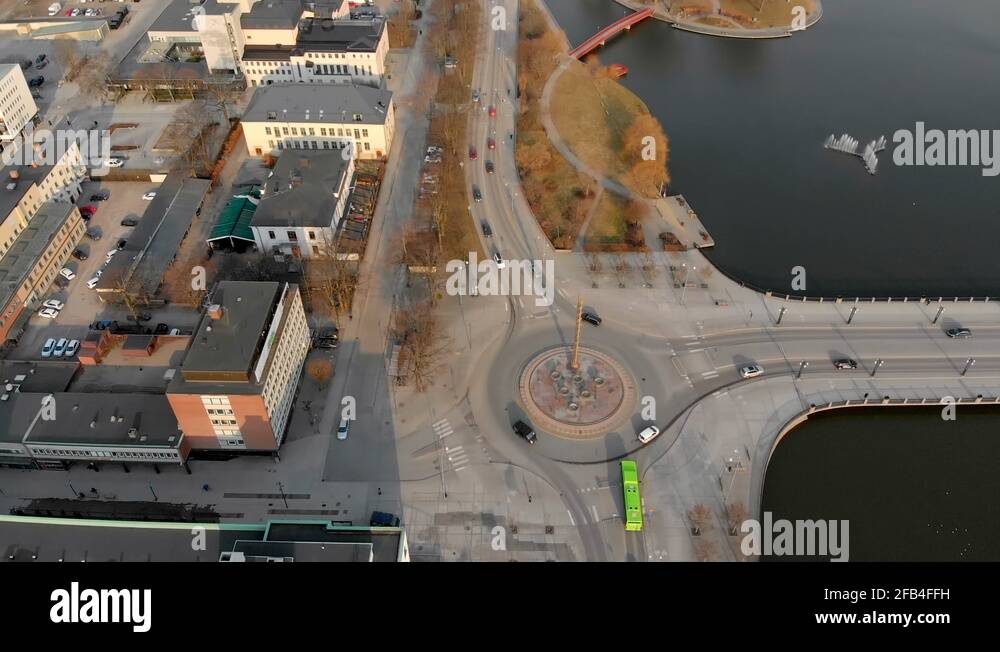 Tilting drone footage showing cars driving in and out of a roundabout, on Stock Video Footage