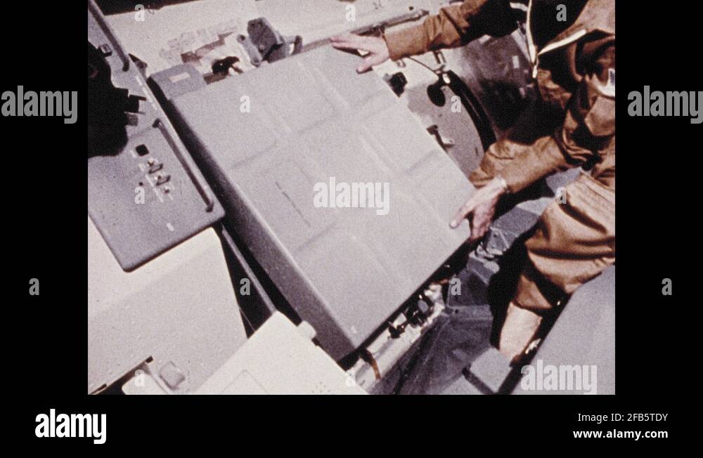 1960s Man lifts cover of control panel. Hand adjusts controls. Man