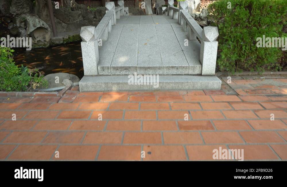 Asian Stone Foot Bridge Crossing Koi Pond Stock Video Footage Alamy