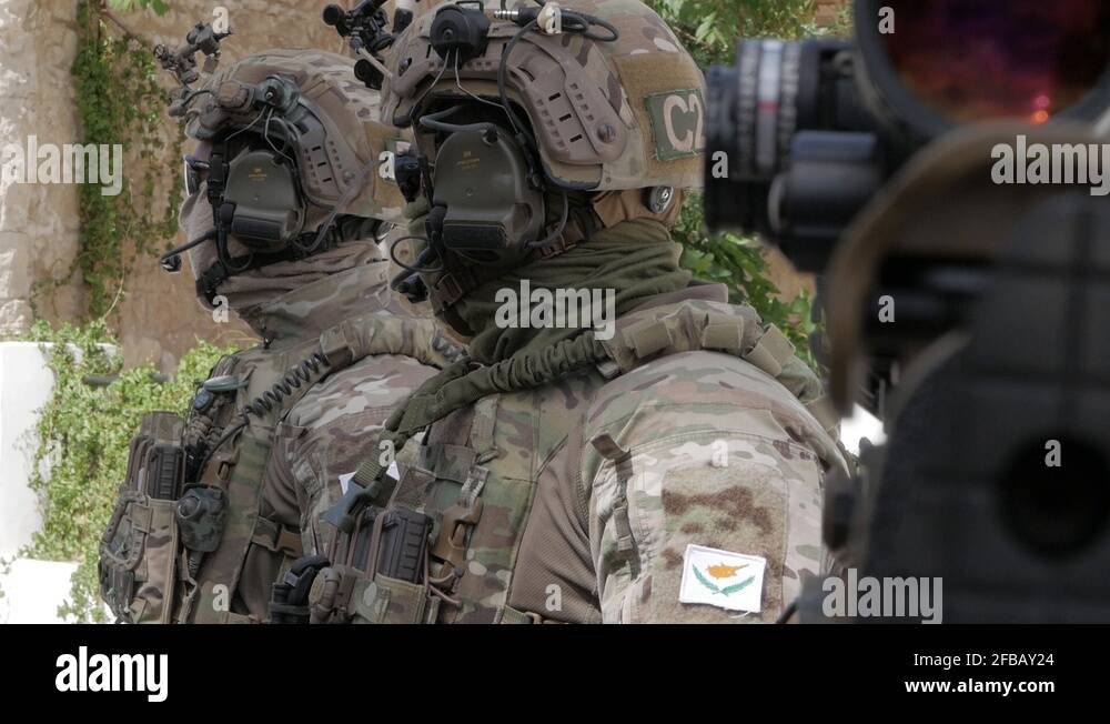 Two soldiers wearing full tactical gear and uniform during the St