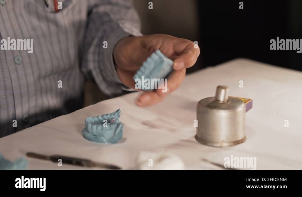 Dentist marking rable partial denture measurements with indelible pencil Stock Video Footage Alamy