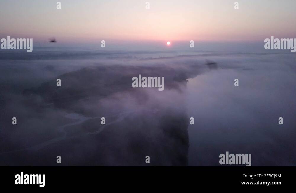 4k aerial view of sunrise above clouds at the landscape park in Poland ...