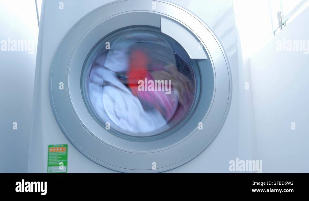 Close Up Industrial Washing Machine Washes Colored Clothing and White