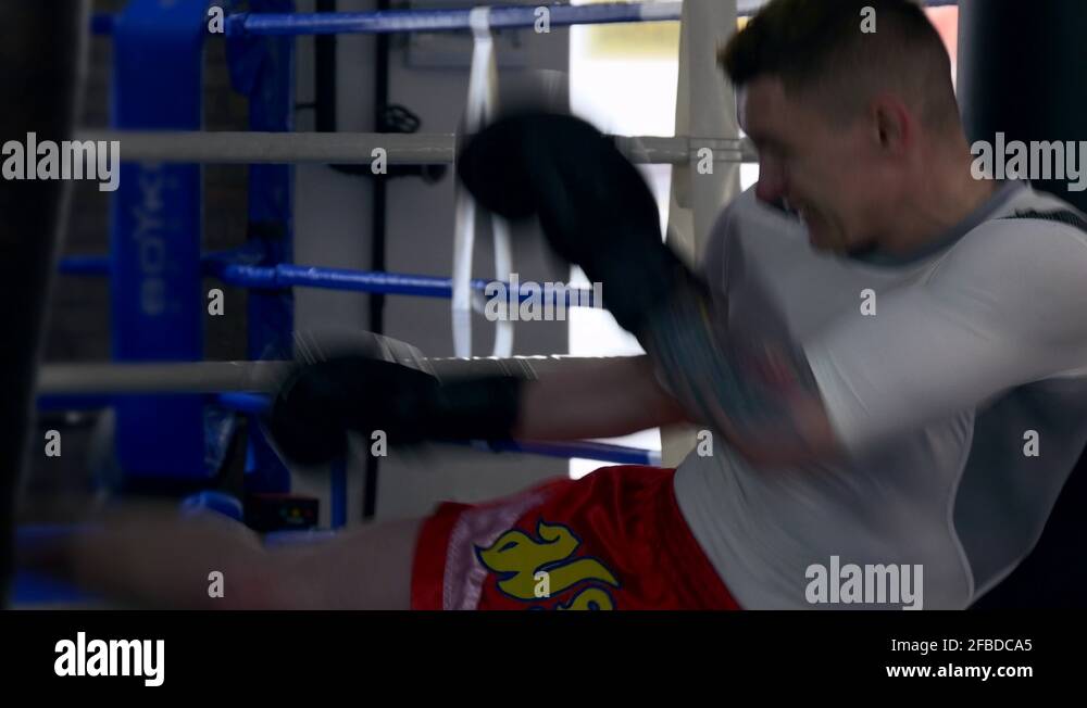 Martial Arts Fighter Kicks and Punches Punch Bag Muay Thai Kickboxer Training 4K Stock Video