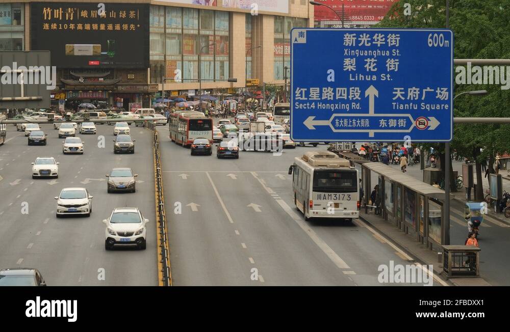 Traffic sign and road with traffic in Chinese city Stock Video Footage