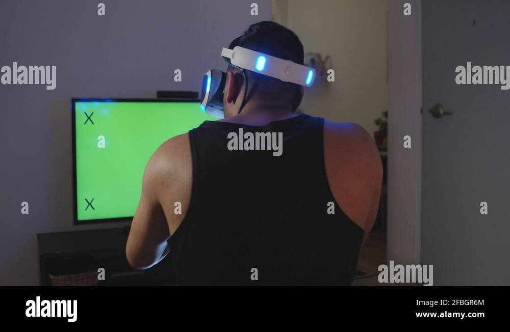 Man Plays Virtual Reality Video Game with Gun and Goggles, Green Screen