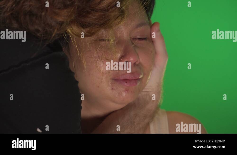 Man consoles woman crying tears on green screen Stock Video Footage - Alamy