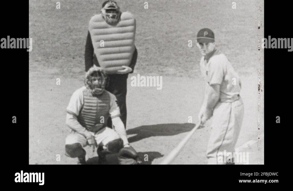 1940s Baseball field, batter misses, catcher catches ball, umpire