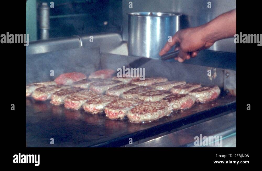 1960s UNITED STATES hand flips steak on grill Stock Video Footage Alamy