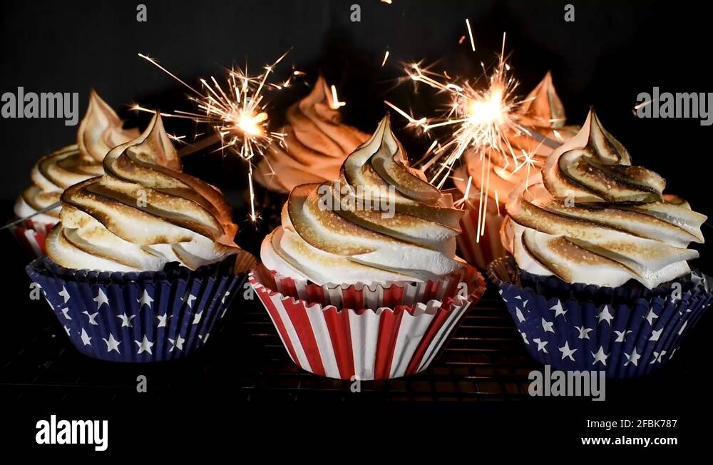 sparklers exploding around red white and blue cupcakes with toasted Stock Video Footage Alamy