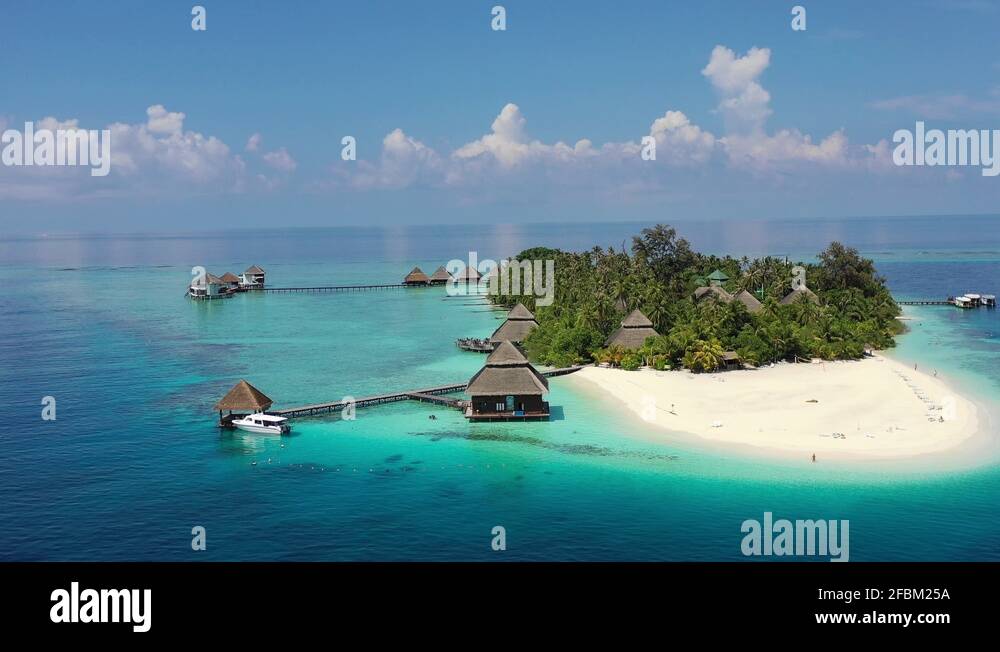 This drone footage shows a panning view of a resort island in the