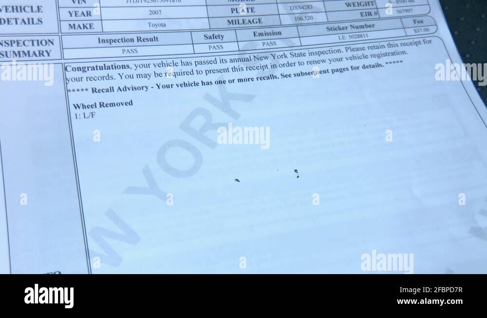 Vehicle emissions inspection being performed on Toyota. Print out of