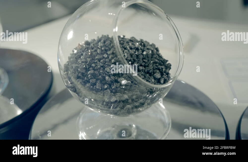 Samples of mineral raw materials of black and white colors in glass containers Stock Video
