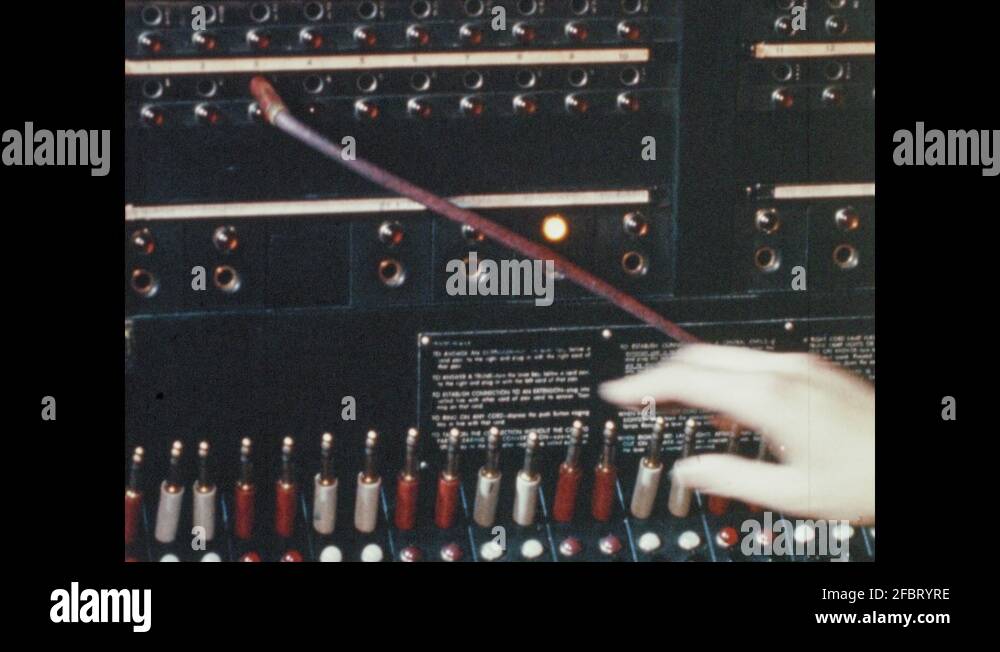 1960s: Woman operated switchboard. Man talks on phone. People talk into ...