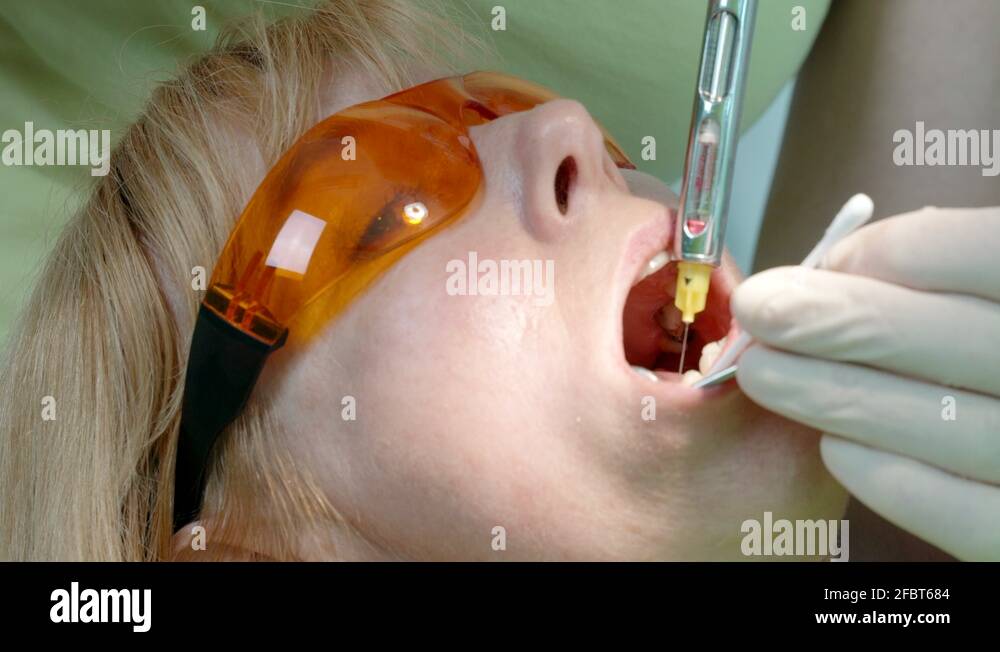 Dentist use anesthetic injection to numb the area around the tooth to