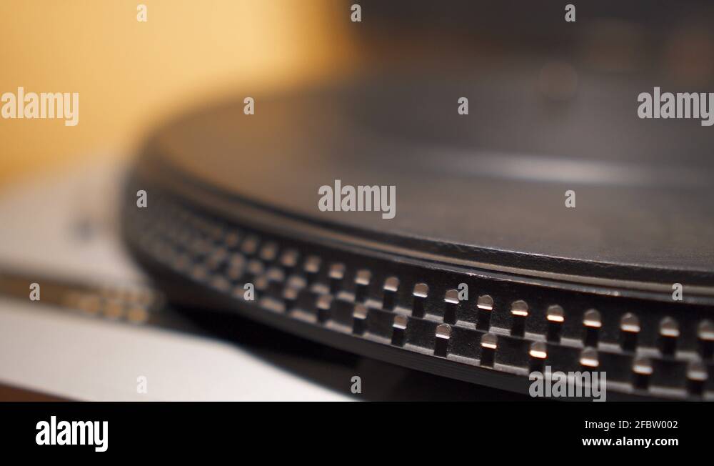 Inserting and ejecting of vinyl disc on a record player closeup view