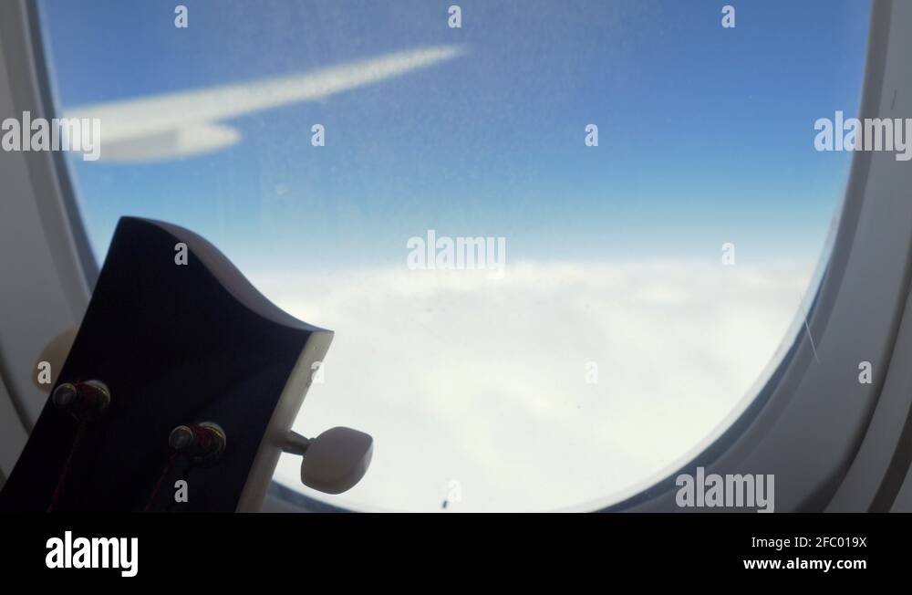 Mast of String instrument beside window of an airplane during flight