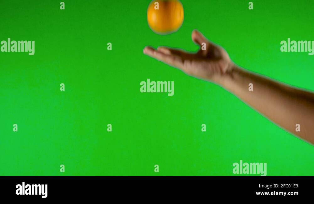 orange with green background throwing up orange with green screen
