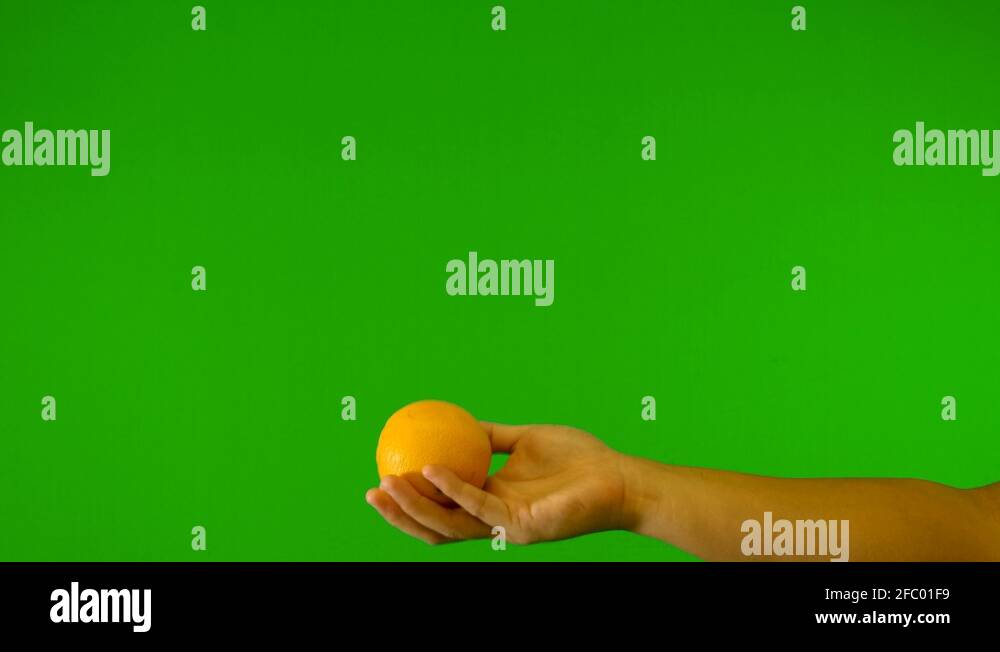 orange with green background throwing up orange with green screen