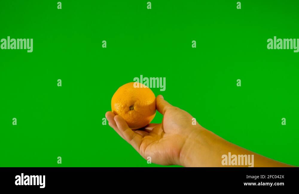 orange with green background throwing up orange with green screen