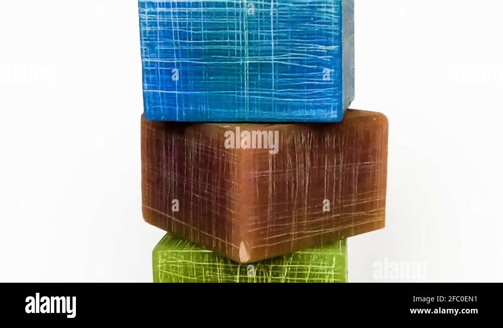 3 different color candles in the shape of squares rotating around with