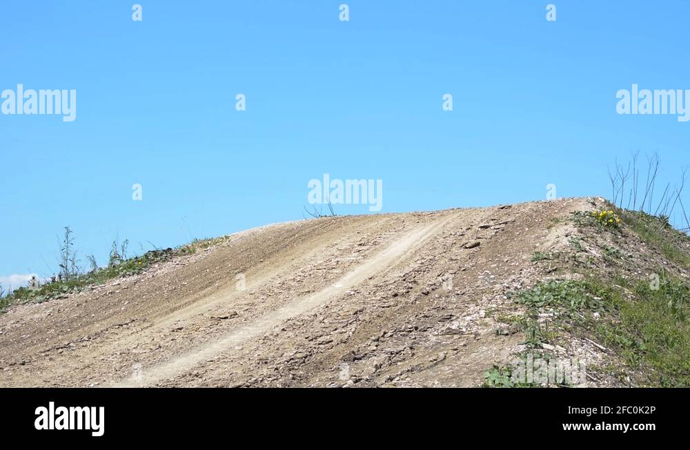 Motocross biker jumps over dirt track ramp Stock Video Footage - Alamy