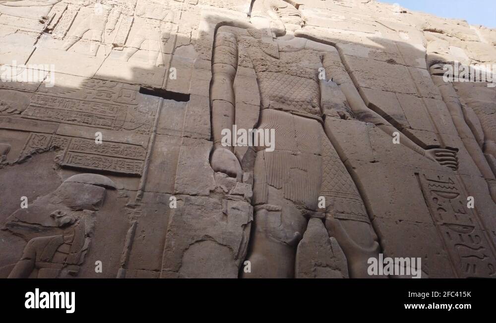 Ancient Egyptian wall carving reliefs at Temple of Kom Ombo, camera pan ...