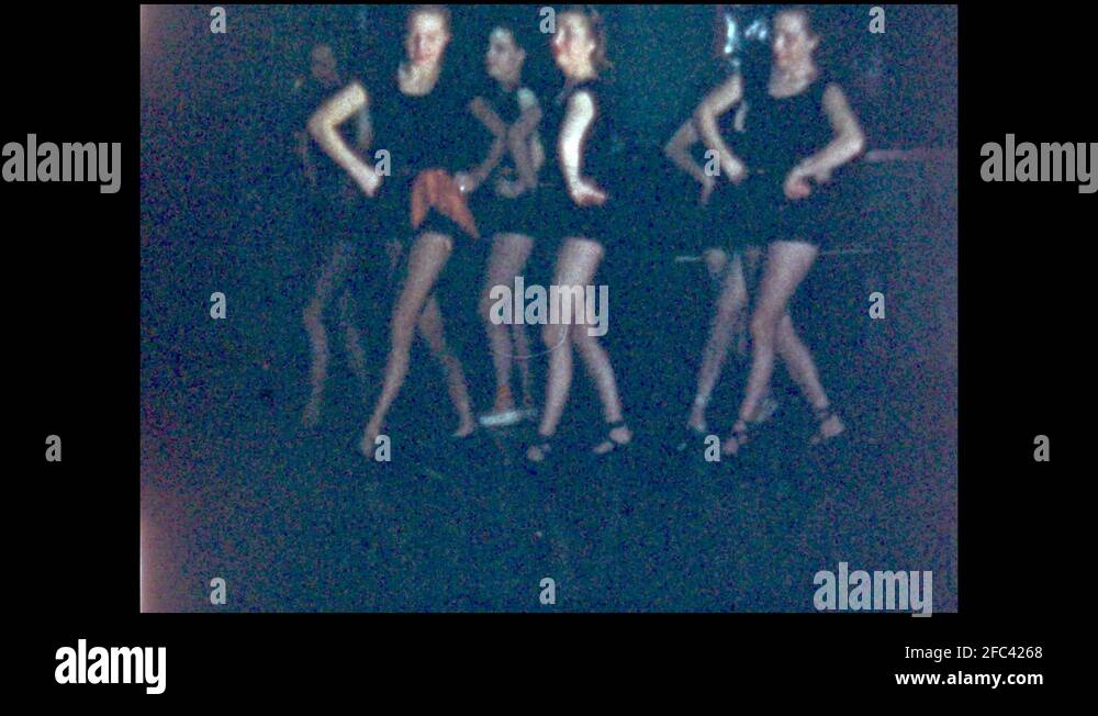 1940s UNITED STATES tap dancers on stage. Ladies dancing in black