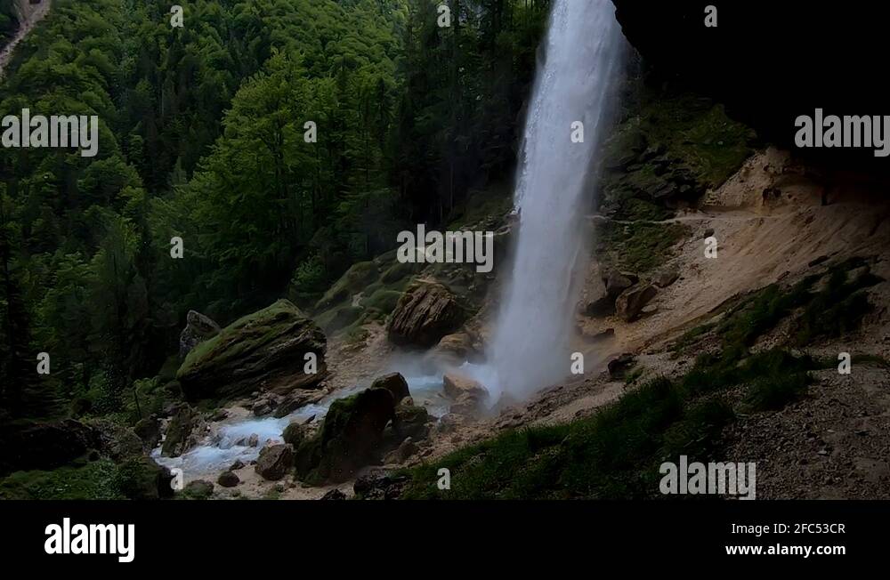 SLOWMO Falling water view under overhang of waterfall Pericnik Stock