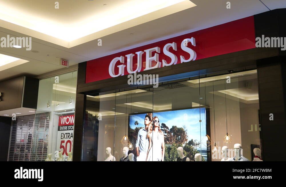 Motion of Guess store sign on wall inside shopping mall with 4k