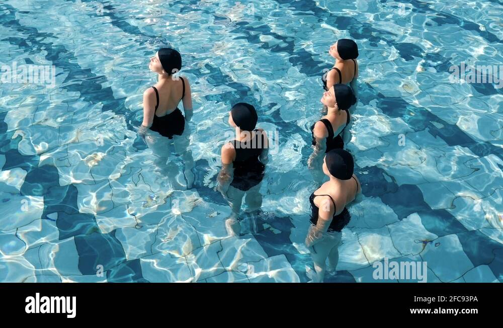 Five girls in the pool take sun treatments. Open-air pool. In summer in ...