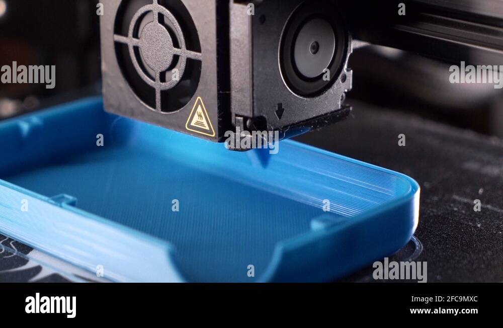 3D printer working. Fused deposition modeling, 3D printer printing an