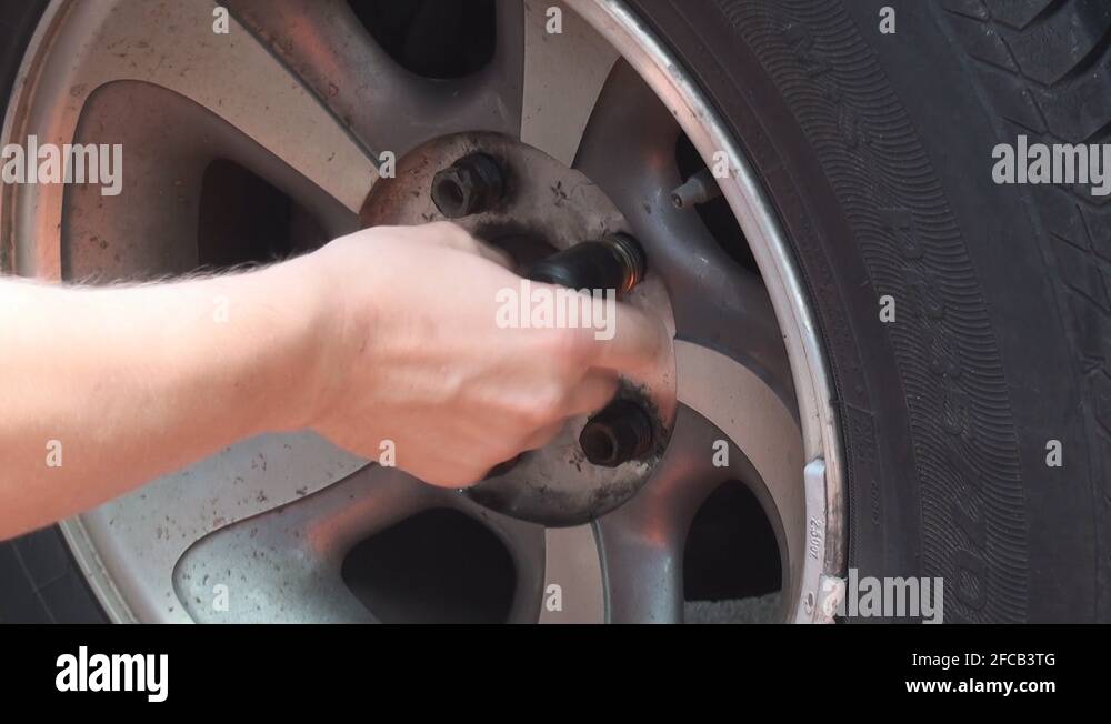 Removing screws from the car wheel Stock Video Footage Alamy